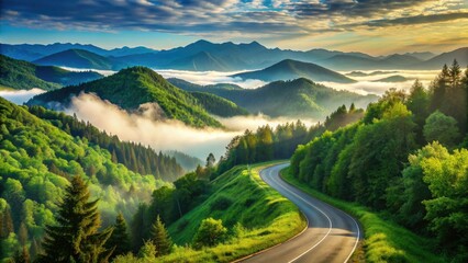 Serpentine mountain road weaves through lush green hills and dense forests, disappearing into the misty horizon under a clear blue summer sky.