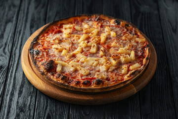 Hawaiian pizza close up on wooden dark background, Italian pizza