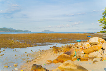 The sea ebb at sunset.
The coastline is the seabed. Seascape of Nha Trang suburb in Vietnam. 