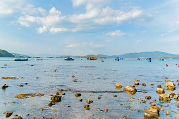 The sea ebb at sunset.
The coastline is the seabed. Seascape of Nha Trang suburb in Vietnam. 