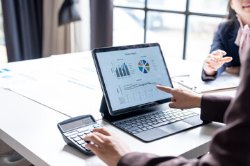 Businesswoman pointing financial chart on digital tablet during corporate meeting