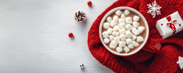 Red mug filled with hot chocolate and marshmallows on knitted blanket