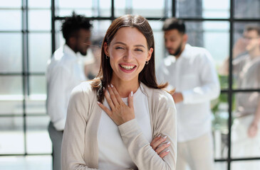 business woman with her staff in background at office