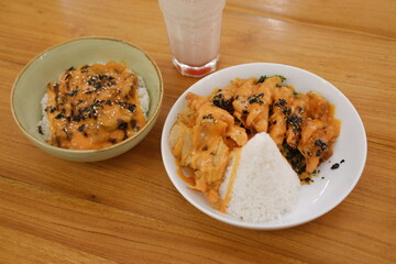 Rice topped with black sesame seeds and dried tomatoes in a bowl