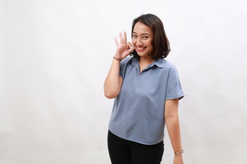 Very good. Smiling asian woman showing okay with satisfied face expression, praise and compliment...
