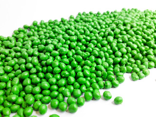 Green prairie masterbatch granules on white background. Color pigment carrier polymer in plastic industry