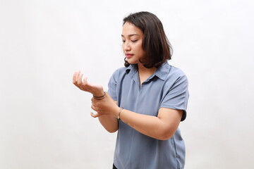 Young asian business female massaging hand suffering from joint pain. Girl having rheumatoid...
