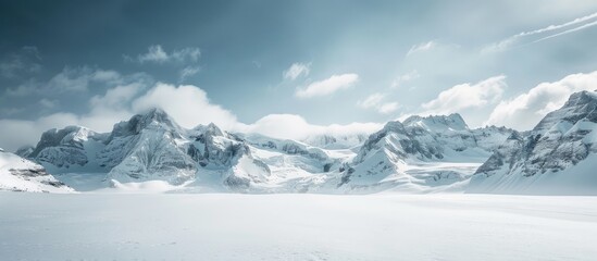 Fototapeta premium Snow-covered mountains and open skies with copy space image.