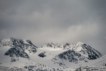 snowy landscape with snow-covered mountains along the road from Alta to Tromsoe, Norway