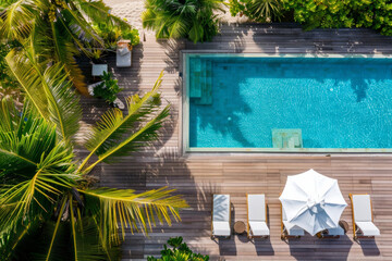 Fototapeta premium Aerial perspective of an expansive luxurious villa nestled on a Maldivian island, showcasing a swimming pool and sun decks shaded by palm trees.