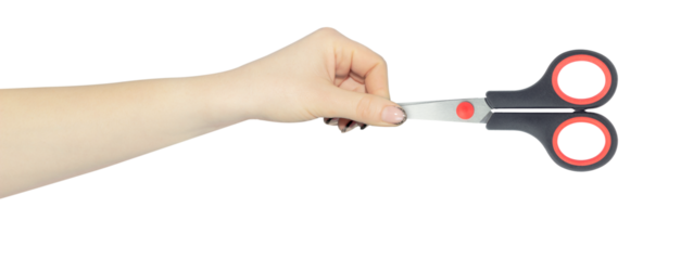 stationery scissors in hand, outstretched hand with scissors isolated from background