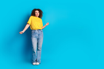 Full size photo of pretty young girl dance have fun discotheque wear trendy striped yellow outfit isolated on blue color background