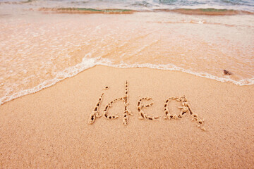 the inscription Idea on the seashore with palm trees