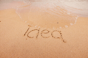 the inscription Idea on the seashore with palm trees