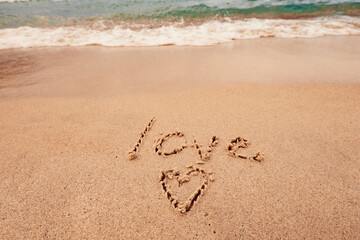 The inscription I love you on the seashore with palm trees
