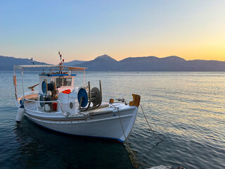 Traditional greek fishing boat with fighing nets in the aegean sea, Greece.