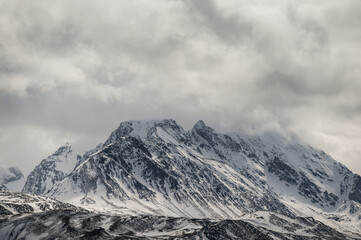 snowy landscape with snow-covered mountains along the road from Alta to Tromsoe, Norway