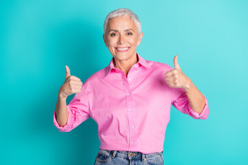 Photo of nice aged woman show thumb up wear pink shirt isolated on teal color background