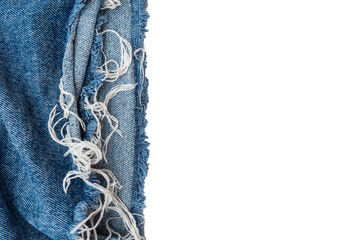 Piece of torn denim on a white background. Denim texture