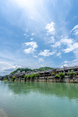 Fototapeta premium Green Water and Traditional Miao Village Architecture by the River in Fenghuang Ancient Town, Xiangxi, Hunan