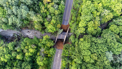 Aerial view of river, road and bridge destroyed by the heavy rain and flood