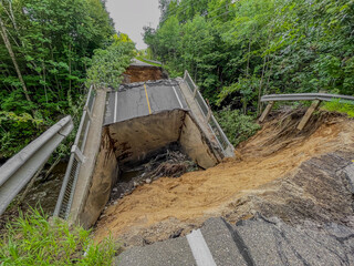 Closeup view of road and bridge destroyed by the heavy rain and flood