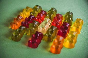 Colorfull gummy bears in a green background