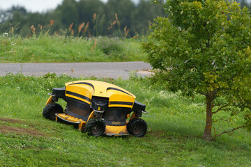 the remote control industrial lawnmower mows the roadside ditch