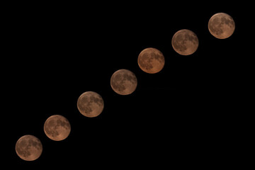 Full moon rising through the dark sky