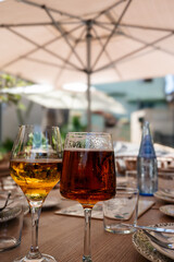 Two glasses of cold beer presiding over the table of diners, vertical framing.