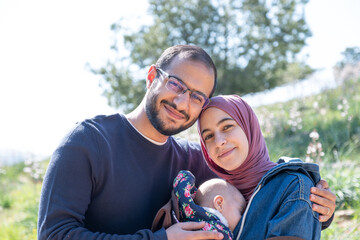 Mother and baby enjoying their time together on a picnic amidst green fields, creating lovely memories