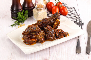 Prepared tasty beef ribs with sauce