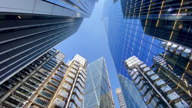 London vertical pan up City Financial District skyscrapers blue sky