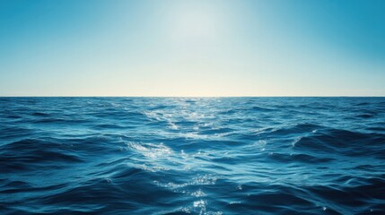 Fototapeta premium A serene view of the open ocean with calm waves and clear blue skies.