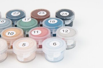 Drawing a picture by numbers with acrylic paints on canvas