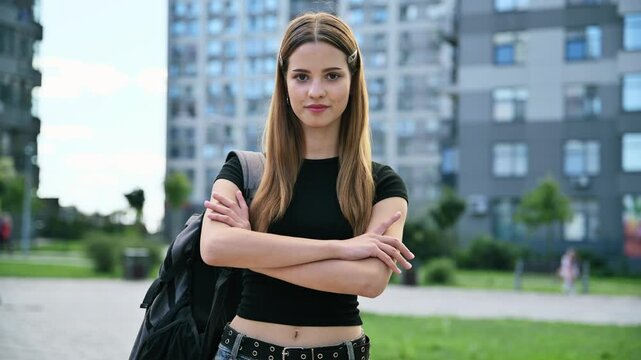 Outdoor portrait young smiling teenager student female with backpack