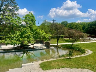 Beautiful summer landscape with lake, trees and blue sky with clouds