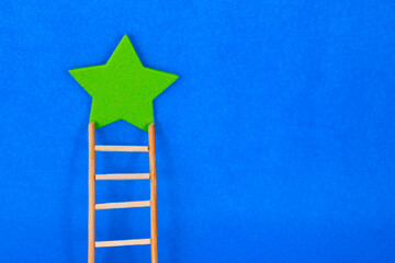 Star and wooden ladder to reach it
