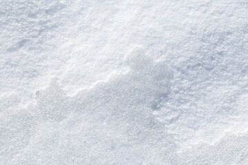 Close-up of fresh and bright snowy land in the winter, viewed from above. Abstract full frame textured background with copy space. Top view.