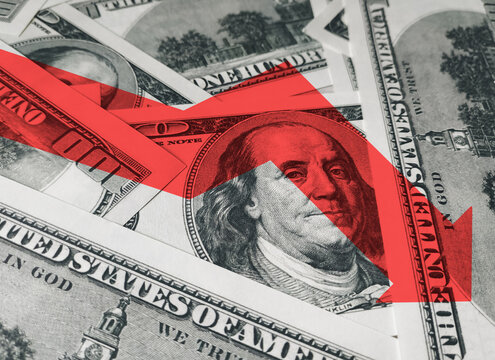 The light red arrow icon on a background of money. The concept of changing course of US dollar on the market. Devaluation, collapse, stagnation of the economy.