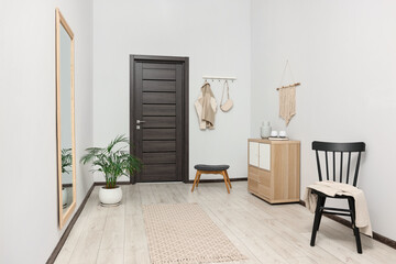Stylish hallway with big mirror and chest of drawers. Interior design