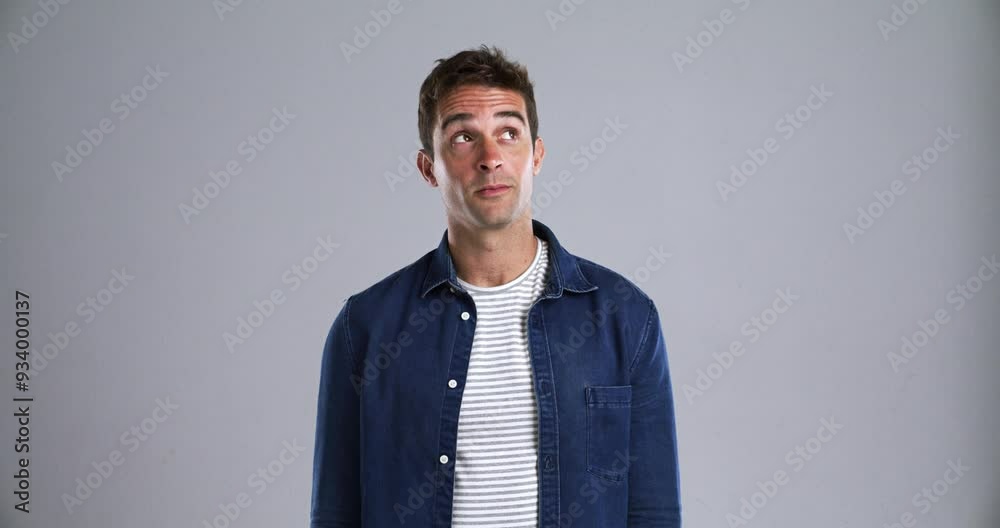 Poster face, smile and a young man thinking in studio isolated on gray background to relax while feeling po