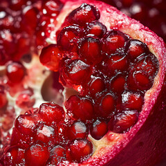 Bursting with Flavor: Macro Shot of Ripe Pomegranate Seeds Crackling Open in Juicy Explosion of Color and Texture