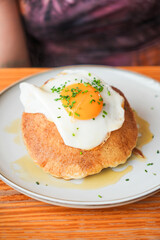 A plate of pancakes with a fried egg on top