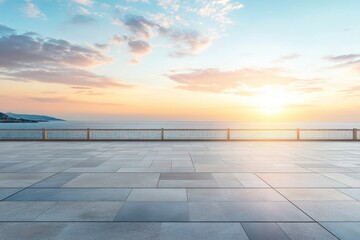 A serene coastal sunset over the ocean with a paved foreground.