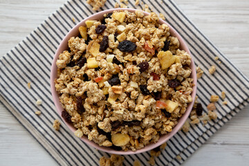 Healthy Homemade Muesli with Fruits in a Pink Bowl, top view. Copy space.