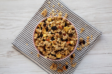 Healthy Homemade Muesli with Fruits in a Pink Bowl, top view. Flat lay, overhead, from above.