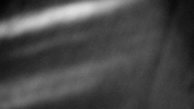Grunge noise texture with light leaks background 4K stop motion video. Blurred backdrop loop footage with grainy effect. Monochrome black and white overlay video