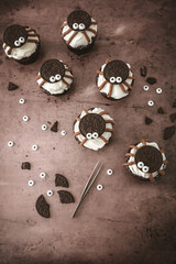 Chocolate Cupcakes with Vanilla Frosting Decorated Like Spiders with Sandwich Cookies