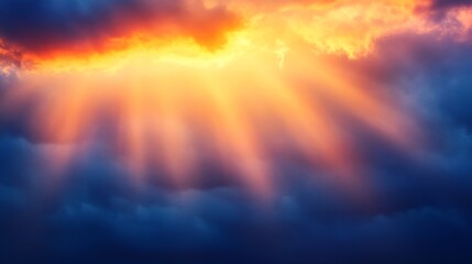 Naklejka premium Brilliant rays of the setting sun illuminating a dramatic sky with gradient colors from deep blue to fiery orange,